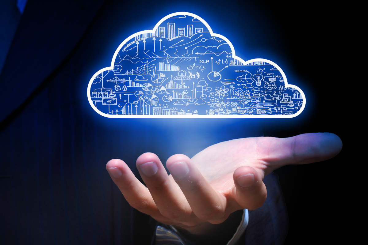 Close up of Businessman's Hand Holding Cloud Graphic Representing Computing
